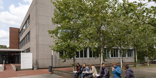 Campus South Students sit on a wall and exchange ideas.